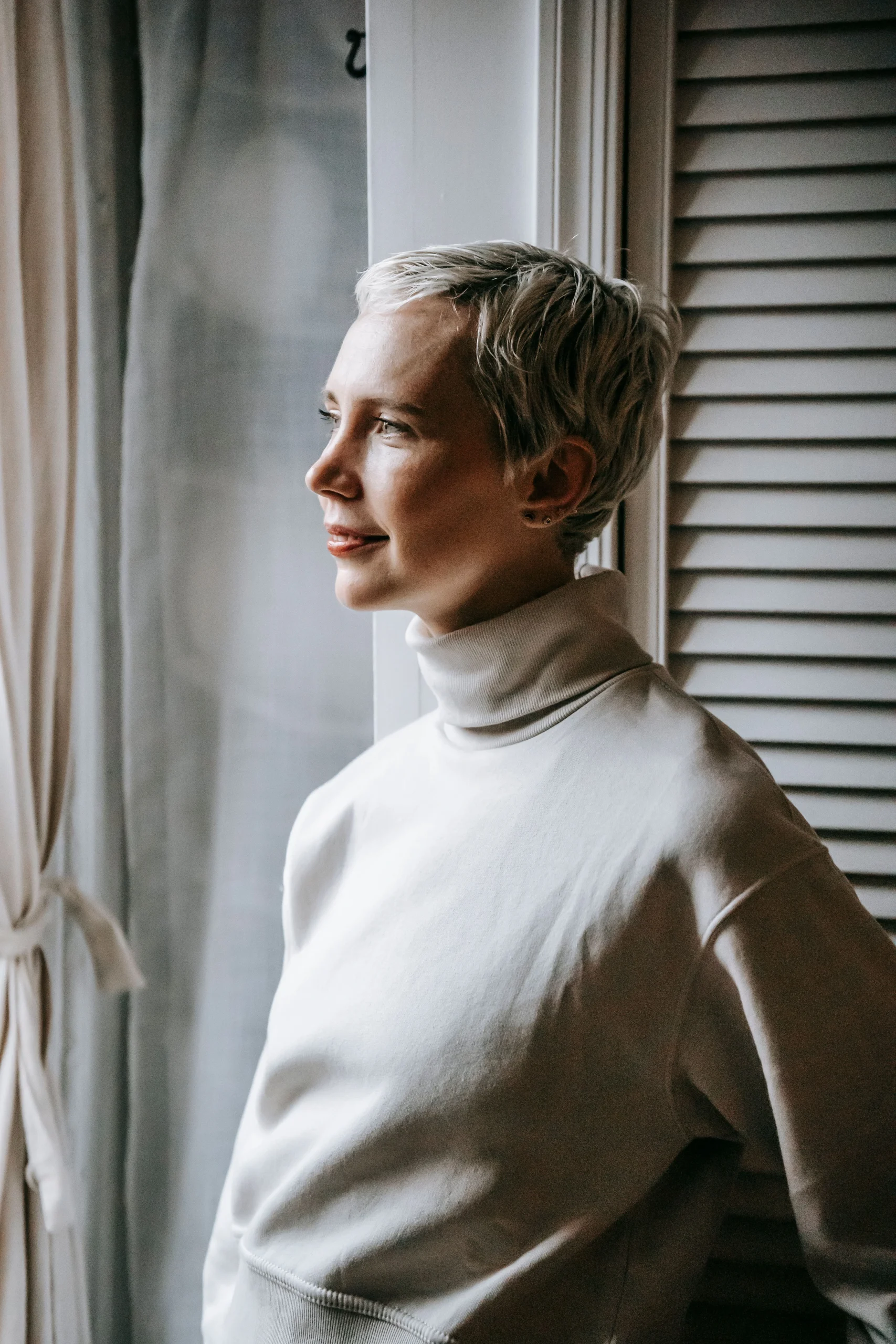 Woman with short hair after shaving her hair due to hair loss.