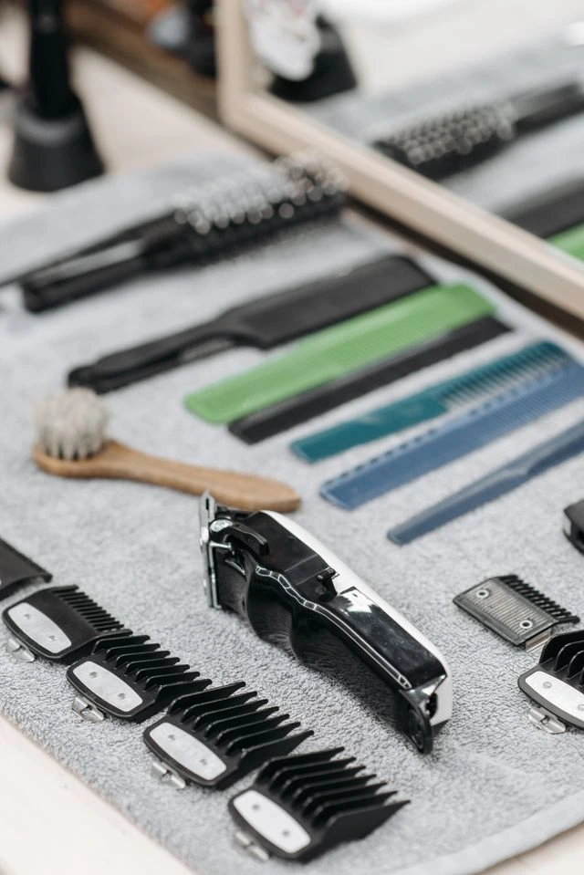 Hair clippers, scissors, and other tools used for shaving women's hair.