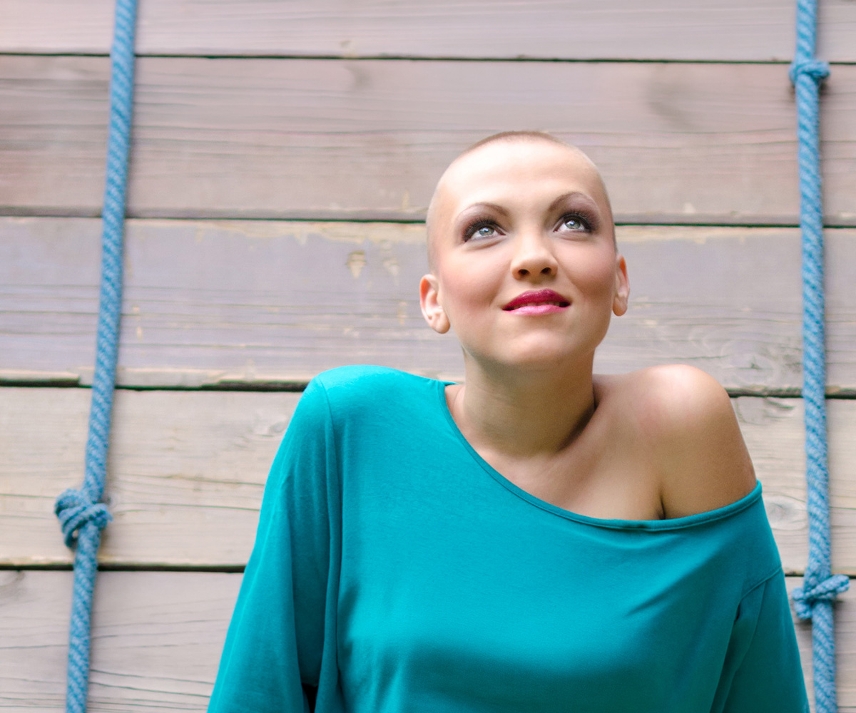 A lady sat on a swing contemplating hair loss