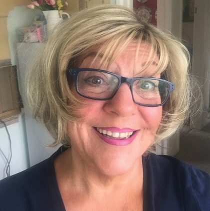 Woman wearing the Sky wig, a short layered crop style with side-swept fringe and soft waves