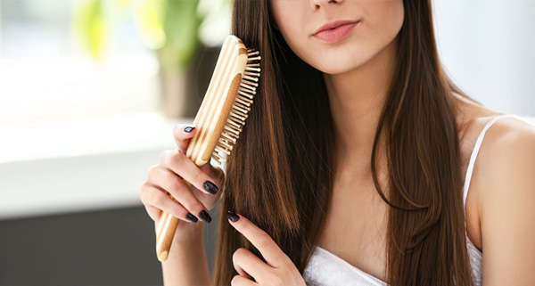 Brushing wig with a wooden wig brush