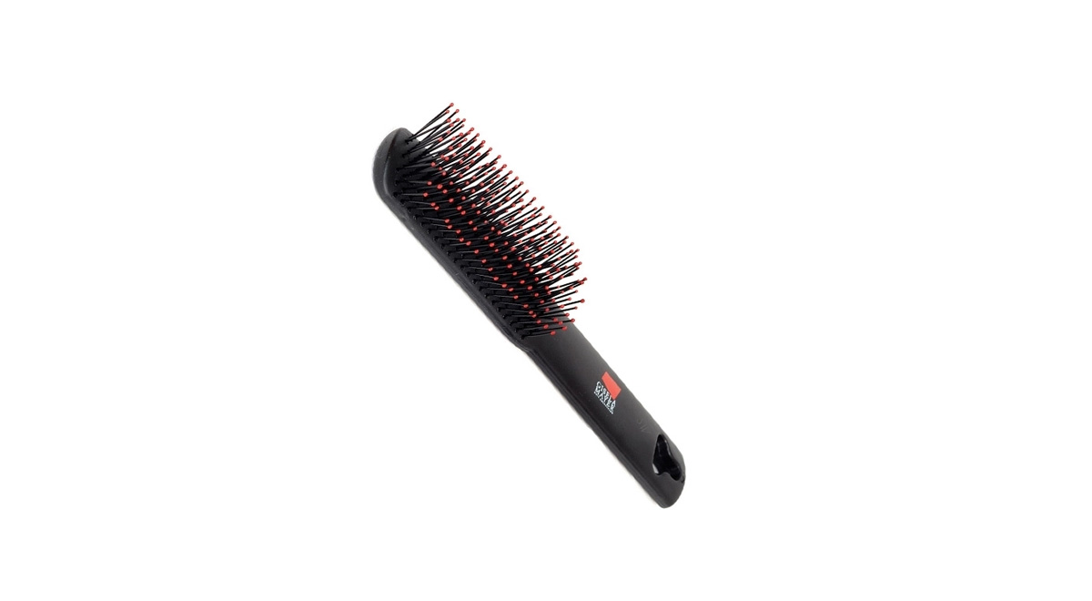 The type of wig brush you may need on holiday or while you travel.